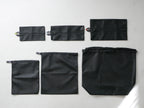 sarasa designの黒いワイドランドリーネット。肩掛けストラップとポケットが付いたポリエステル製の洗濯用バッグ